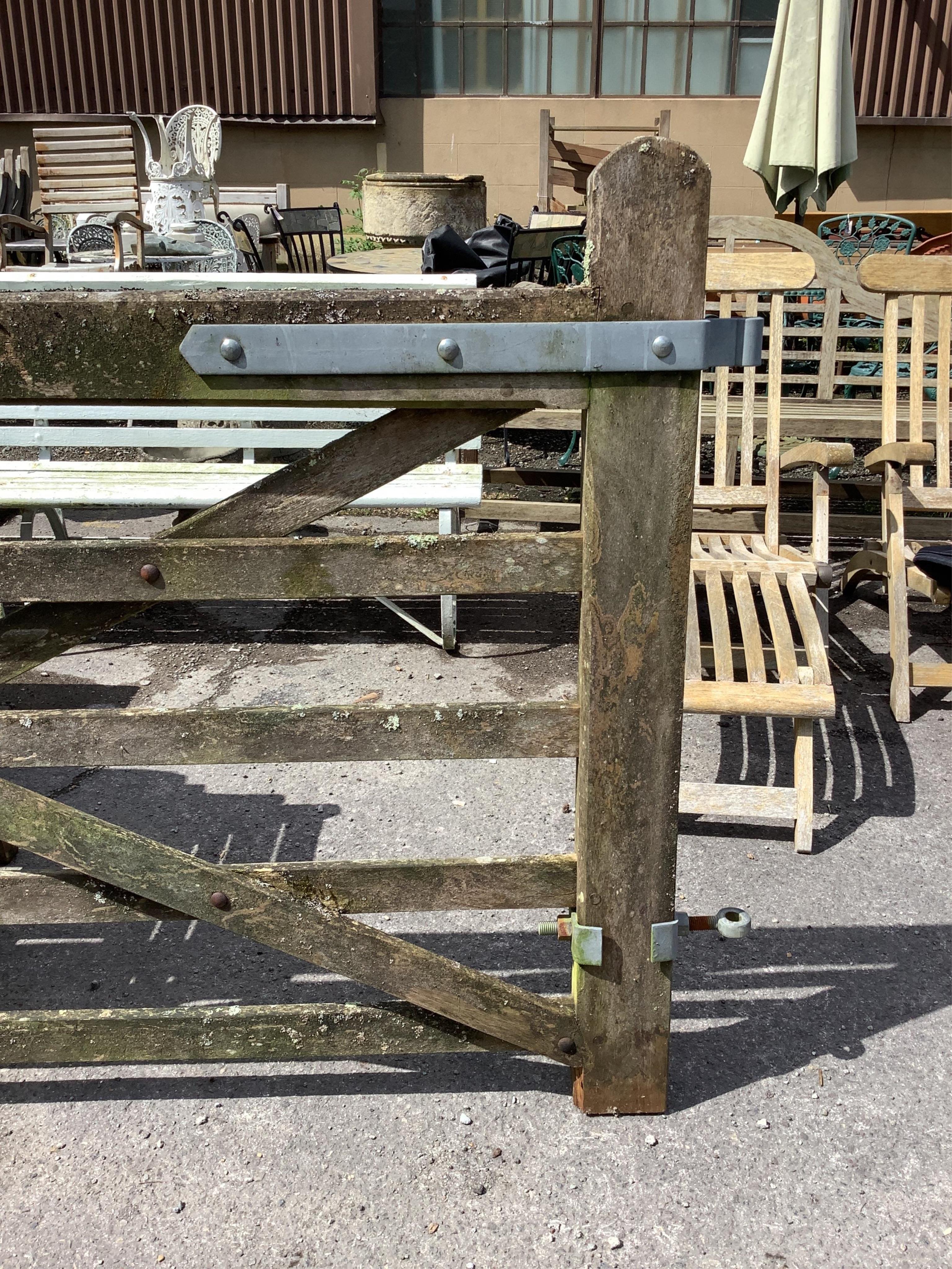 A pair of 12ft Biddenden hardwood gates with galvanised mounts. Condition - poor to fair